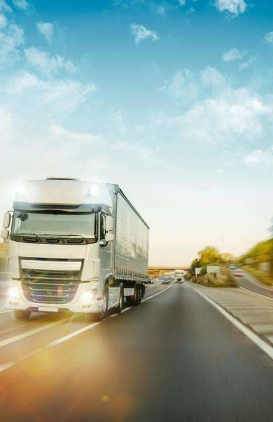 truck driving with headlights on